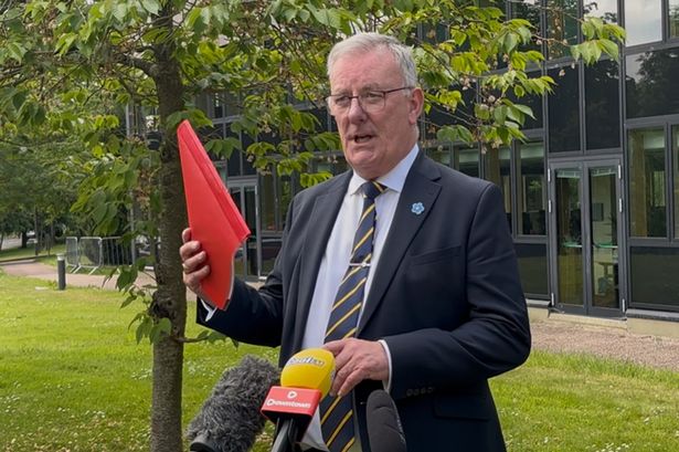 Stormont Health Minister Mike Nesbitt speaks to media outside the Department of Health