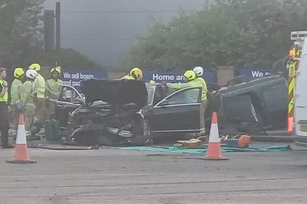 Two cars were involved in an early morning crash in Newtown (one, believed to be a Mercedes, pictured with front end damage and the other ending up on its roof, with a man and a woman, believed to be the drivers of the cars, suffering serious injuries and being taken to hospital 