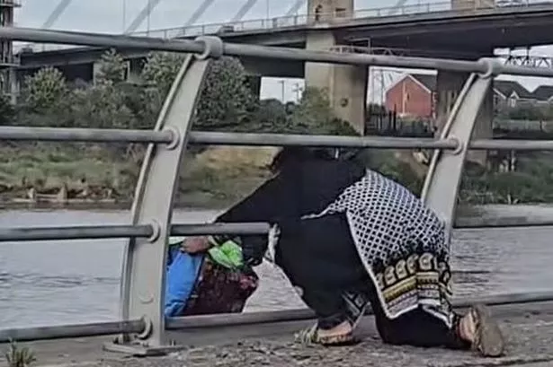 The woman is seen in the footage casually walking up to the river side and turning the shopping bag upside down to release waste into the water below
