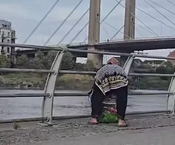 The image shows the woman with her back to the camera