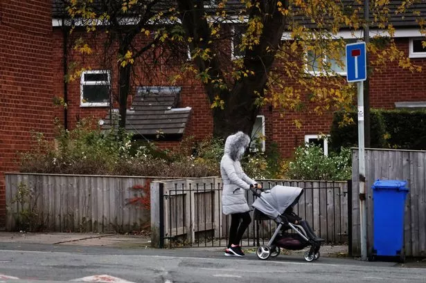 A mother with a pushchair in Fallowfield