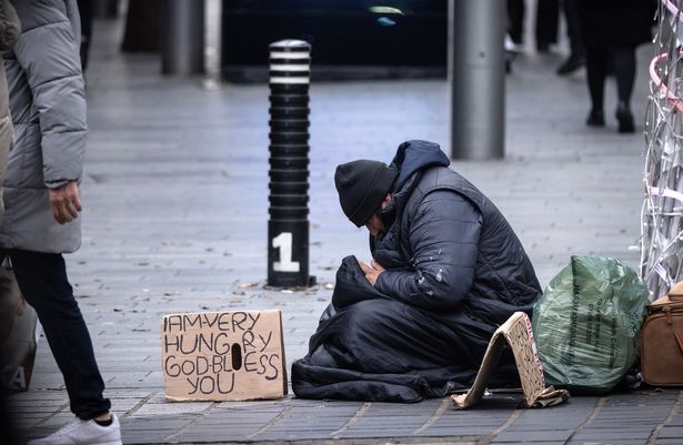 A rough sleeper begging in Liverpool city centre