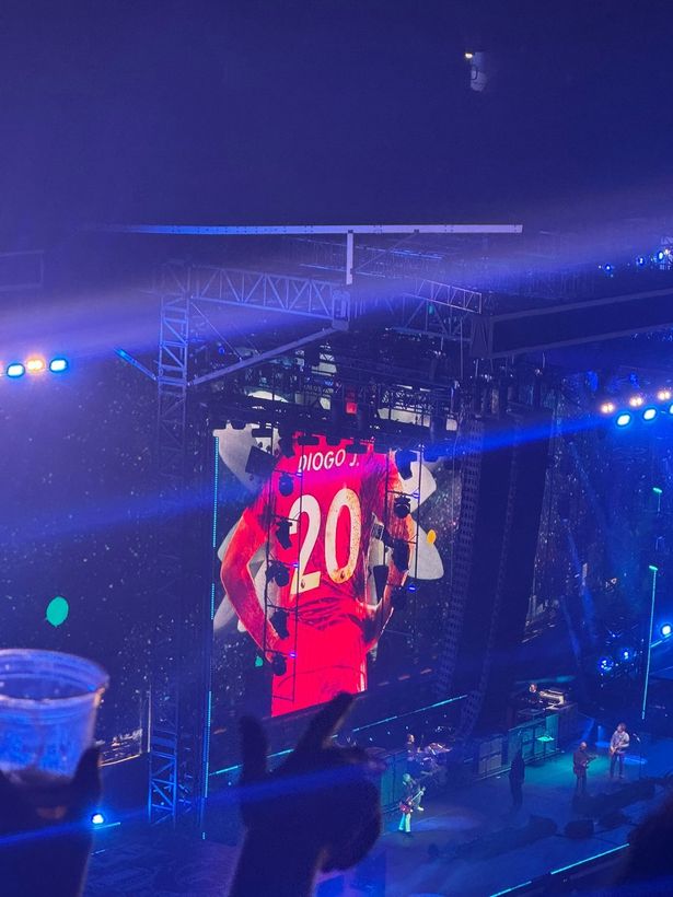 Jota 20 red Liverpool shirt on screen at concert