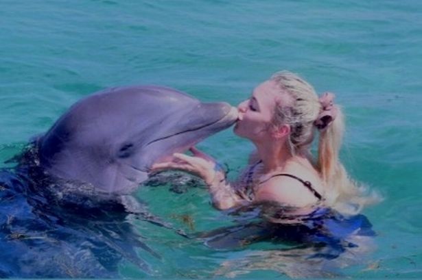 Corrie star told by PETA to 'open her eyes' after she shares snap riding dolphin