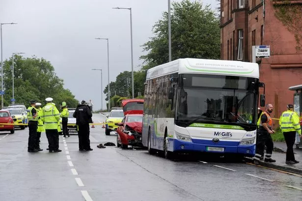 Police on the scene of the crash between the car and the bus in Elderslie