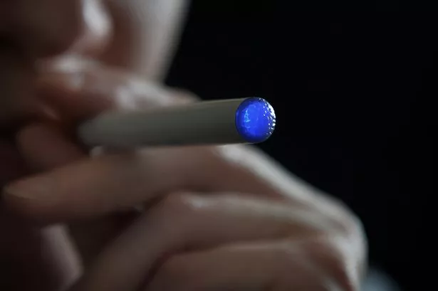 A person smoking an electronic cigarette