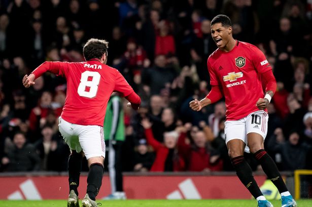 Marcus Rashford celebrates with Juan Mata after a Manchester United goal.