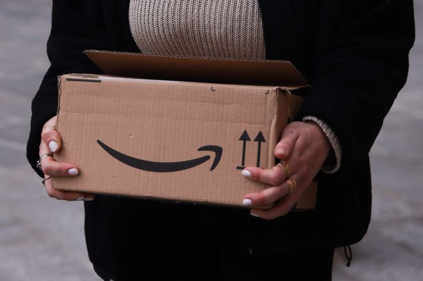 A person carries Amazon Prime paper box 