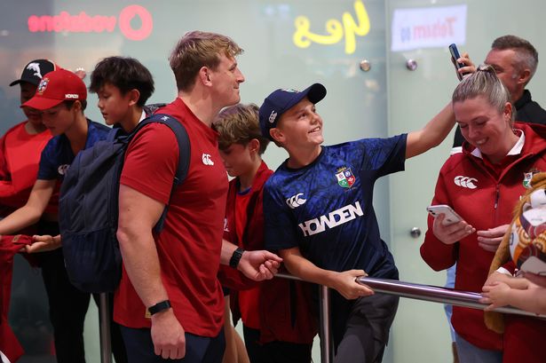 Jac Morgan of The British & Irish Lions poses for a selfie with a supporter after arriving in Australia