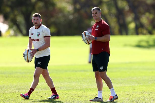 Finn Russell (L) looks on with Johnny Sexton, the Lions kicking coach
