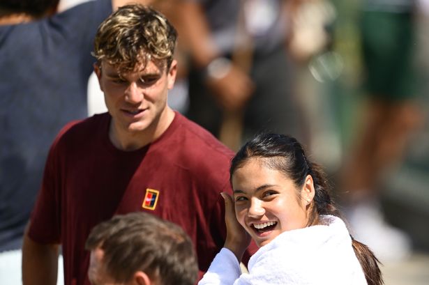 Emma Raducanu looks on during a practice session alongside Jack Draper 