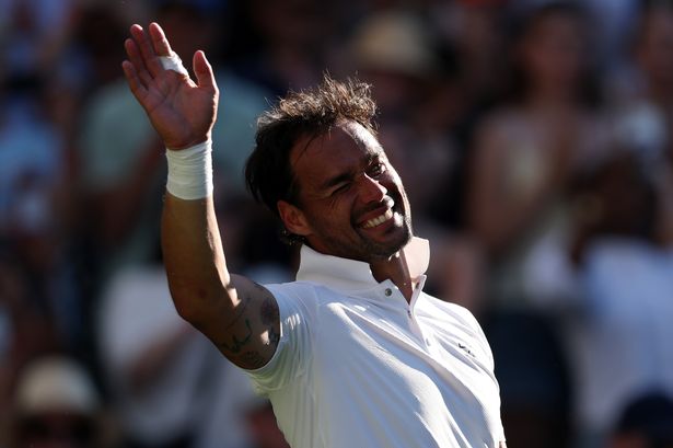 Fabio Fognini of Italy acknowledges the crowd following defeat against Carlos Alcaraz