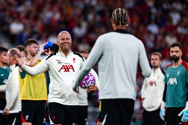 Arne Slot, head coach and Hugo Ekitike of Liverpool during a pre-season training session 