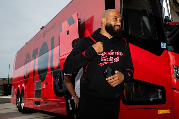 Bryan Mbeumo walks past the Manchester United team bus.