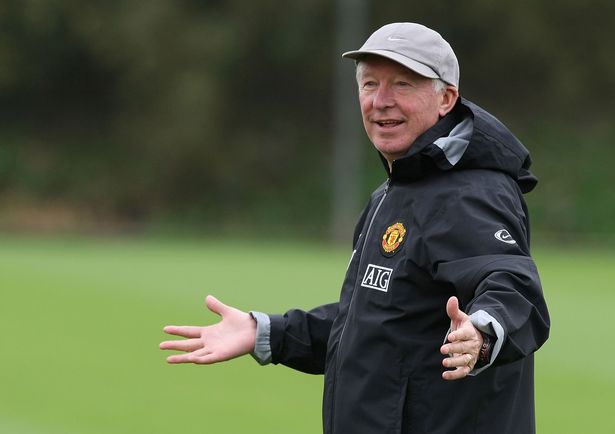 Former Manchester United boss Sir Alex Ferguson smiles during a training session at Carrington.