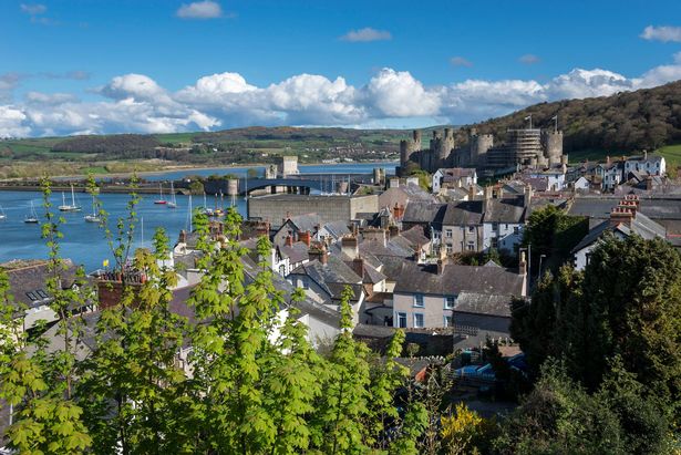 The old walled town of Conwy on the coast of North Wales. View of the Castle and harbour by the side of the river.