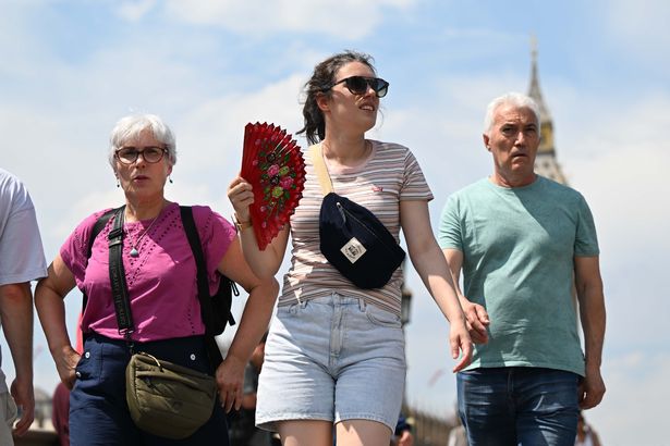 People are seen weaving fans at street near Big Ben in London, United Kingdom on July 1, 2025. 