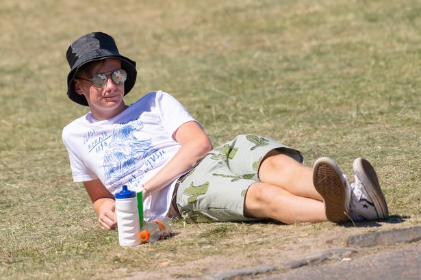 A festival goers enjoys the sun on the second day of the TRNSMT Festival at Glasgow Green on June 30, 2018 in Glasgow, Scotland.