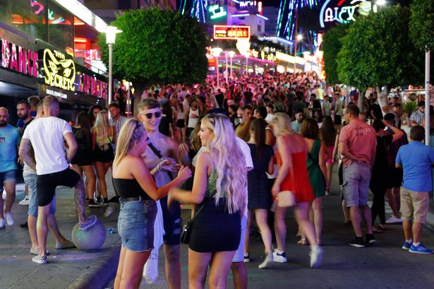Tourists visit the popular Punta Ballena strip in Magaluf