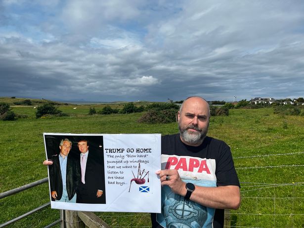 Protestor Matt Halliday with a 'Trump go home' sign