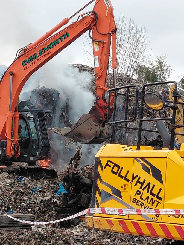 Machinery is being used to move the rubbish and continue to put out the fire