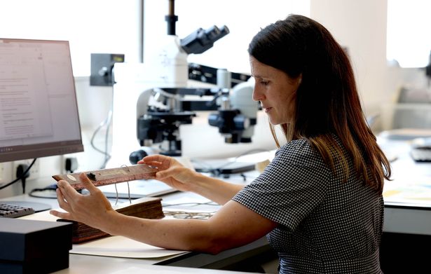 A conservator at the John Rylands Library works on an item from the collection