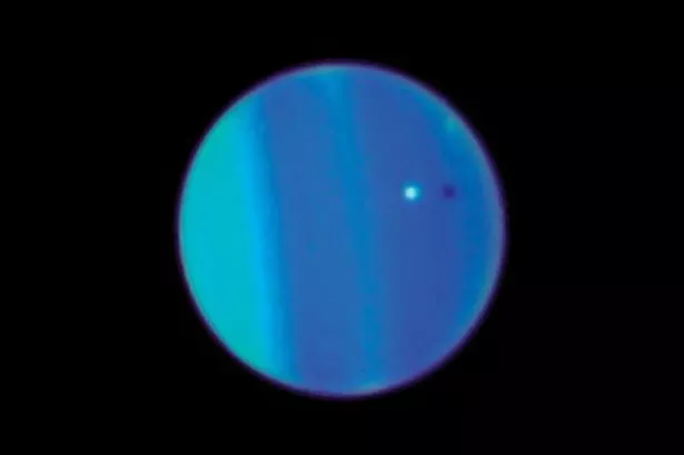This 2006 image provided by NASA shows an image of Uranus with its moon 