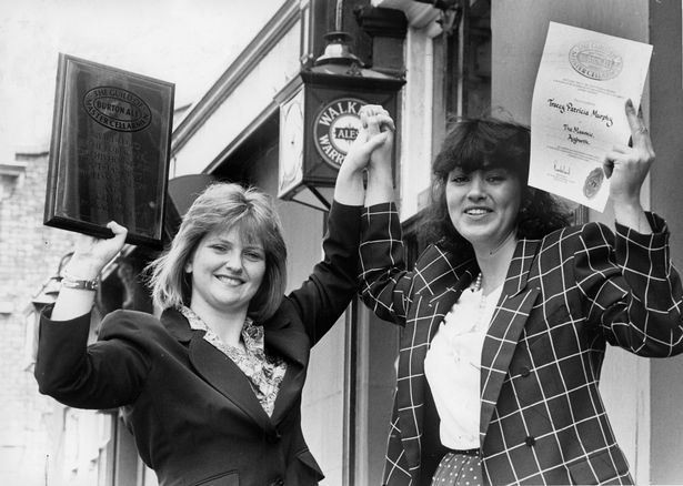 Tracy Murphy (right), the licensee at the Masonic Pub in Lark Lane, Liverpool, proudly displays her certificate confirming her acceptance as a a member of the Guild of Master Cellermen. May 24, 1991