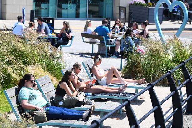 Workers relaxing in the sunshine in Princes Dock 