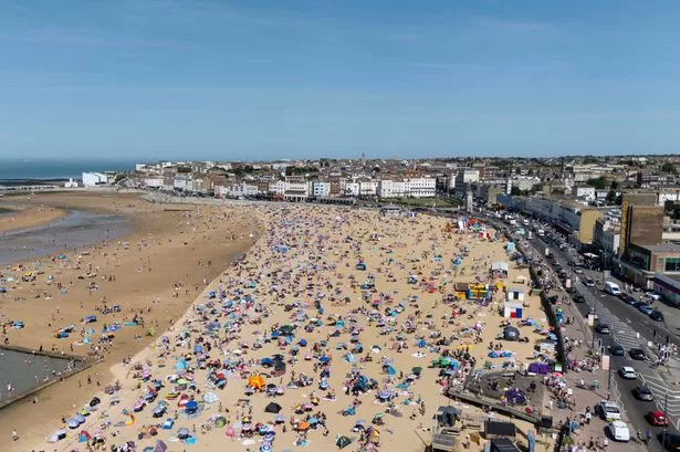 People enjoy the warm weather on the beach in Margate in Kent
