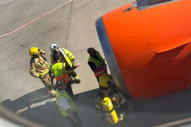 Emergency services inspect an engine on an easyJet flight after it returned to Liverpool airport 