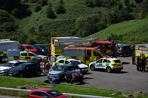 An image of police vehicles, ambulances and fire engines in a car park.