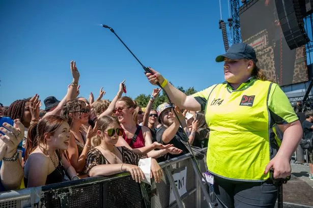 Stewards cool down fans with water at the TRNSMT festival.
