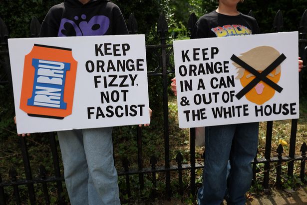Demonstrators hold placards during a 'Stop Trump Coalition' protest outside the US Consulate building in Edinburgh