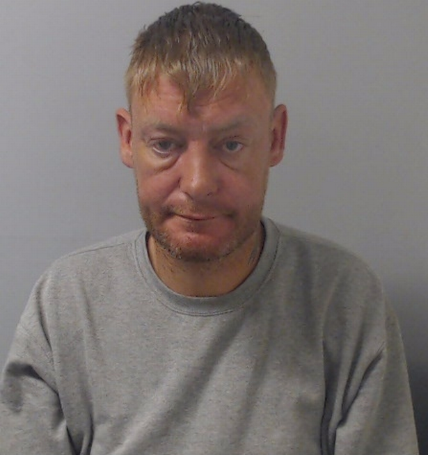 Jason Murray police custody picture wearing grey sweatshirt with medium length blond hair 