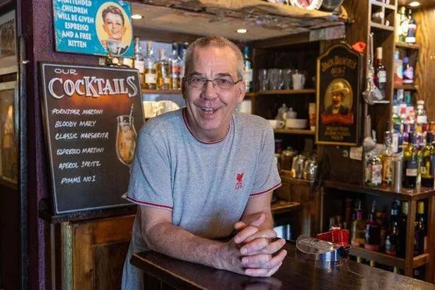 John Search smiles behind bar at Peak Hotel