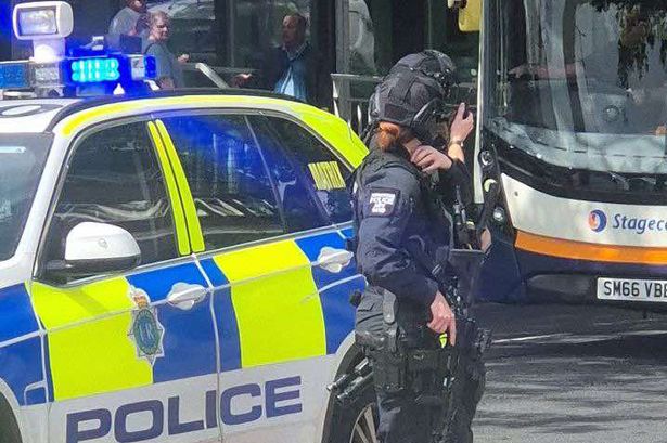 Armed police officers at the scene in Kirkby