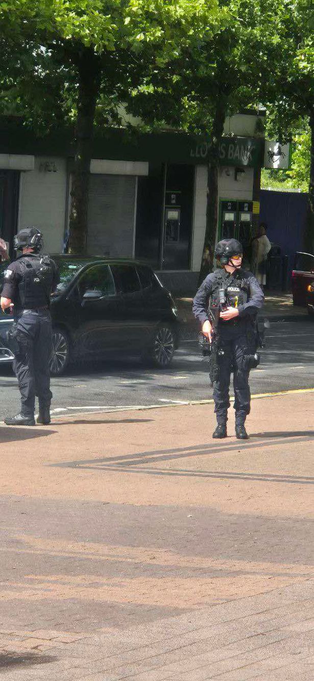 Armed police are searching the property for the suspected firearm