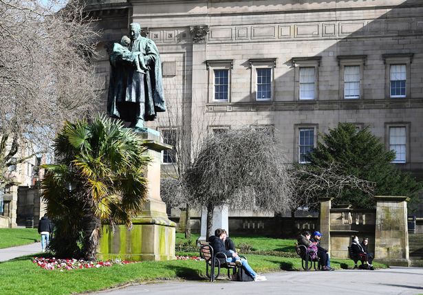 People relaxing in St John's Gardens
