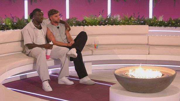 Dejon and Harry on Love Island around the firepit