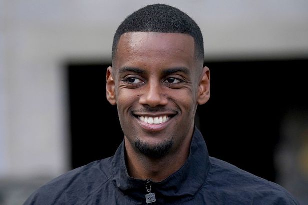 Alexander Isak smiling while arriving before a Newcastle United match