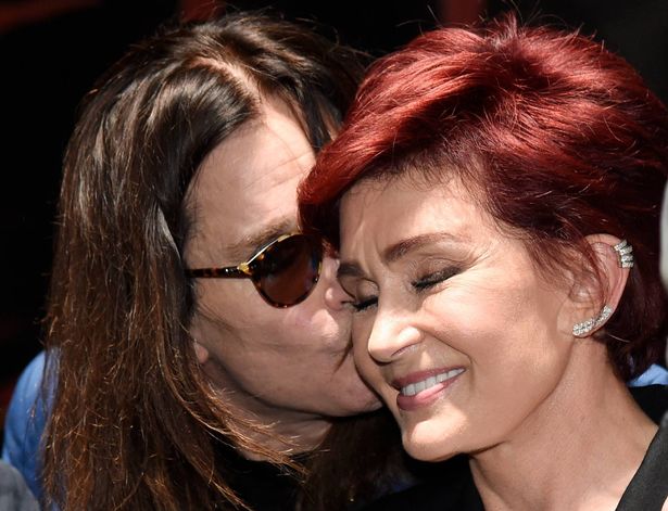 Ozzy Osbourne kisses his wife Sharon