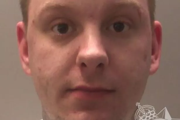 Custody photo of Paul Harris, 28, who has short brown hair, a neck tattoo, and is wearing a white T-shirt
