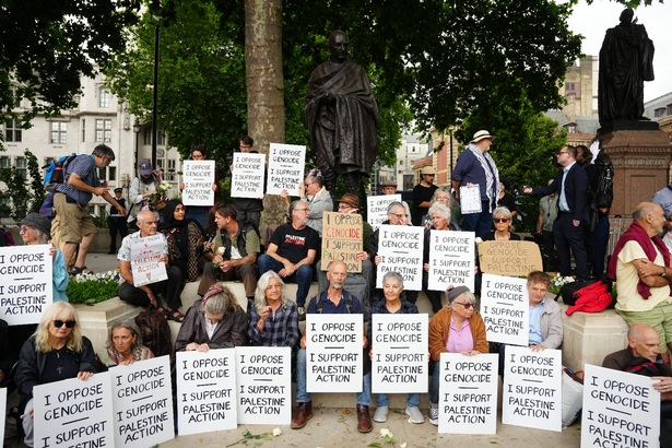People take part in a protest in support of Palestine Action, organised by the Defend Our Juries group, in front of the Mahatma Gandhii statue in Parliament Square, central London. Picture date: Saturday July 5, 2025.