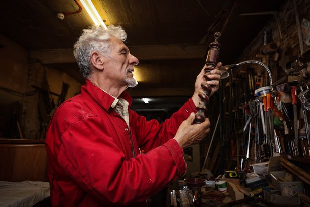 Selwyn Hyams, owner of Pilgrim's Progress Antiques at work in the woodwork shop