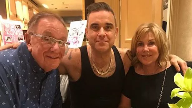 Robbie Williams sat in between his dad Peter and his mother Janet.