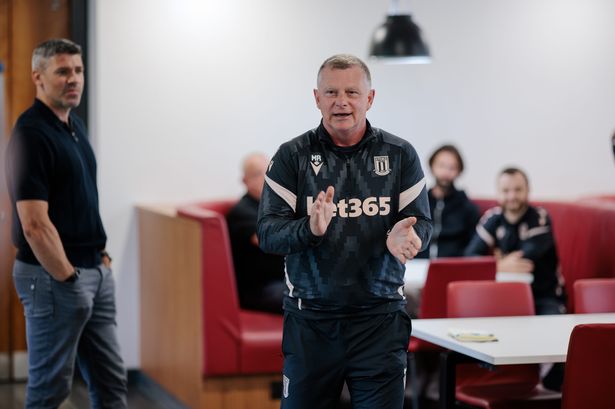 Manager Mark Robins talks to his squad as Stoke City return for pre-season training.