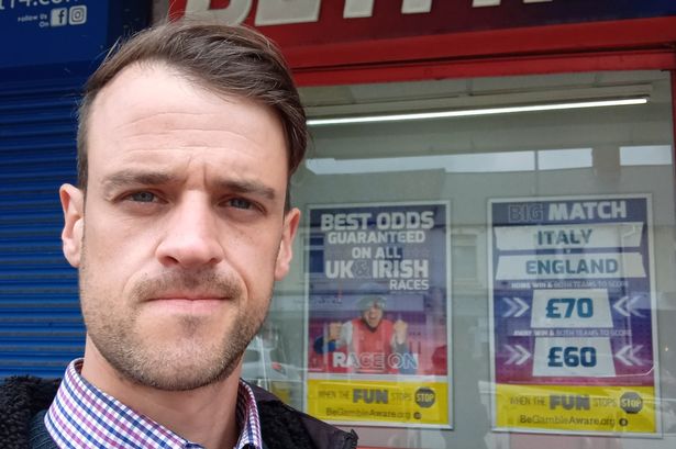 Gambling addict Samuel Badcock outside of a Betfred
