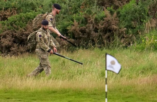 Soldiers search the first green at the Trump Turnberry course ahead of U.S. President Donald Trump's visit.