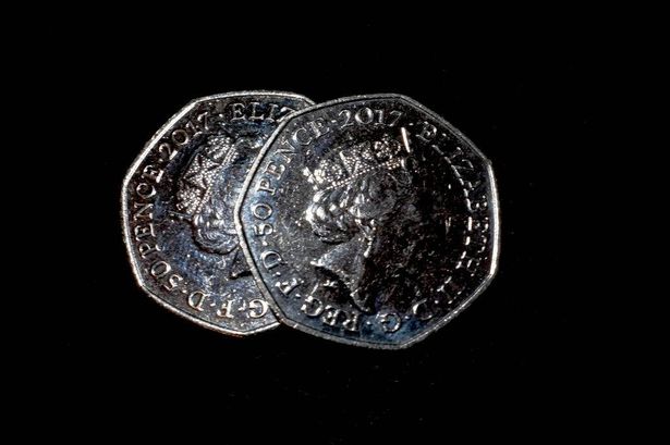 A 50p coin is pictured in a composition